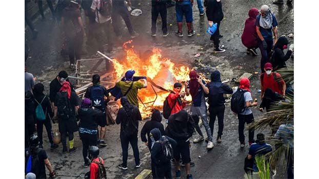 Protesters in Chile set fire to university, loot church