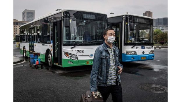 Hubei lifts restrictions as China reports no new virus cases