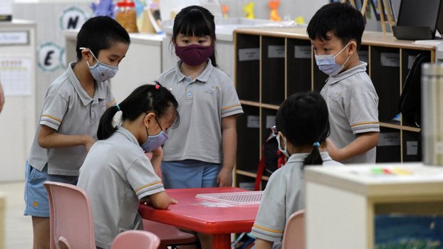 Back to school in masks as  Singapore eases virus curbs
