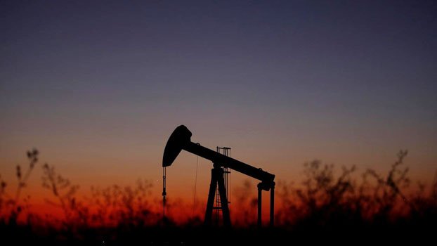 Oil rises on U.S. crude stockpile draw, global manufacturing activity