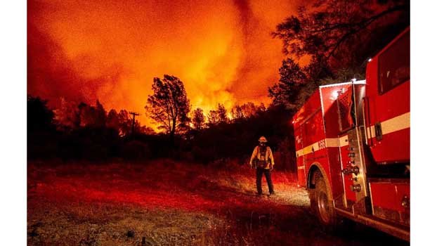 US towns destroyed as firefighters battle wildfires under orange skies