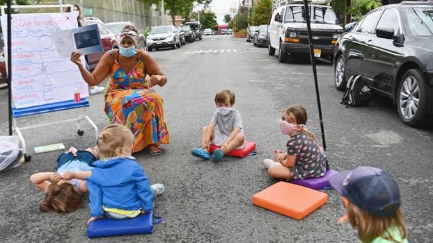 New York City delays return  to school again