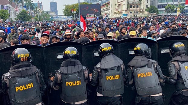 Protests against new labour law turn violent across Indonesia
