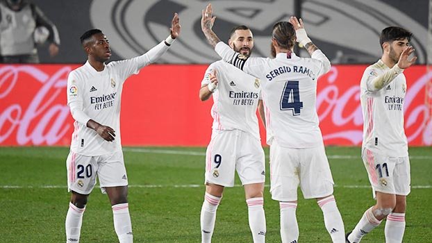 Real ease past Granada to join Atletico at top of Liga