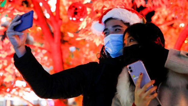 China hails its ‘extraordinary’ success curbing virus ahead of WHO probe