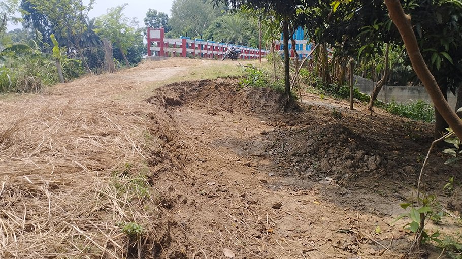 Farmer couple removing soil of wing wall of sluice gate