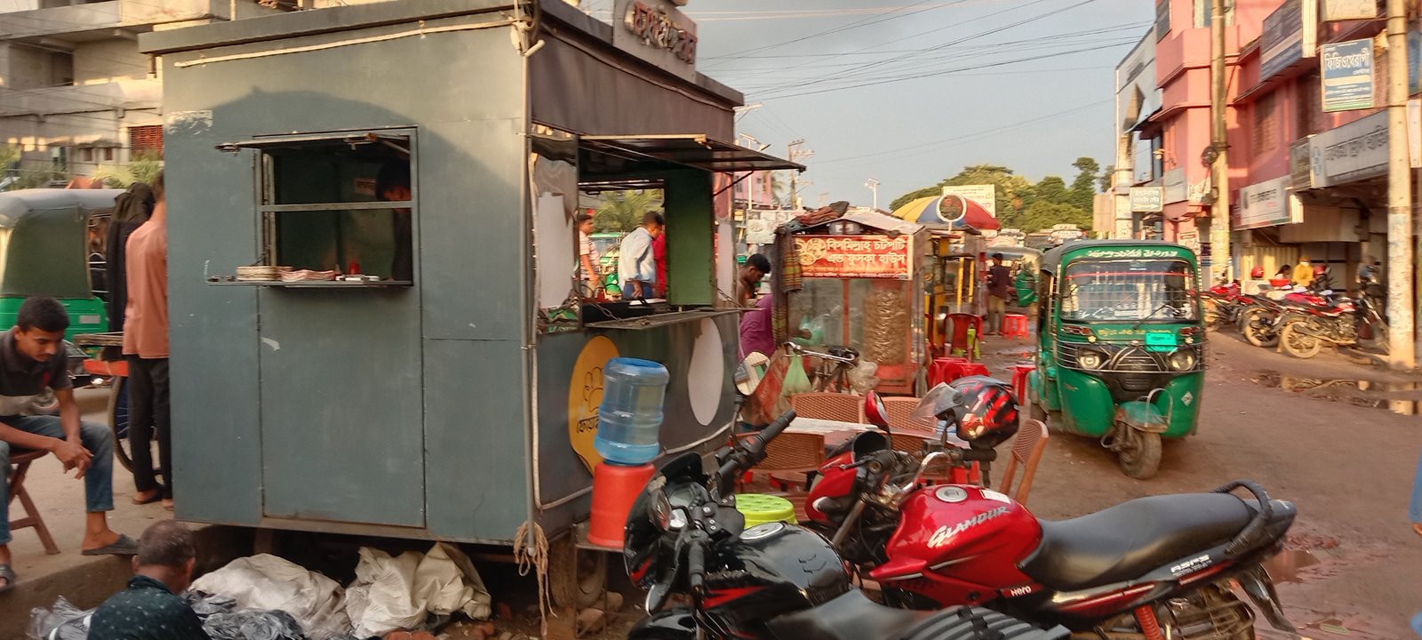 Illegal stalls occupy footpaths in Raozan, forcing pedestrians onto roads