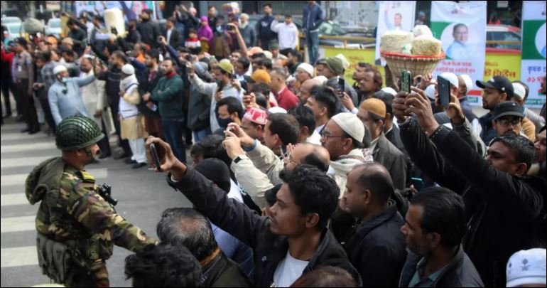 Through cold and fog, mourners gather to bid farewell to Khaleda